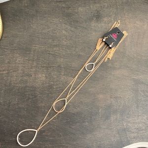 Faux gold layered necklace featuring faux diamonds with matching earrings.